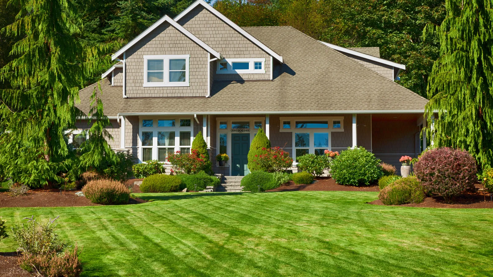 Home with a healthy green lawn and tidy landscaping